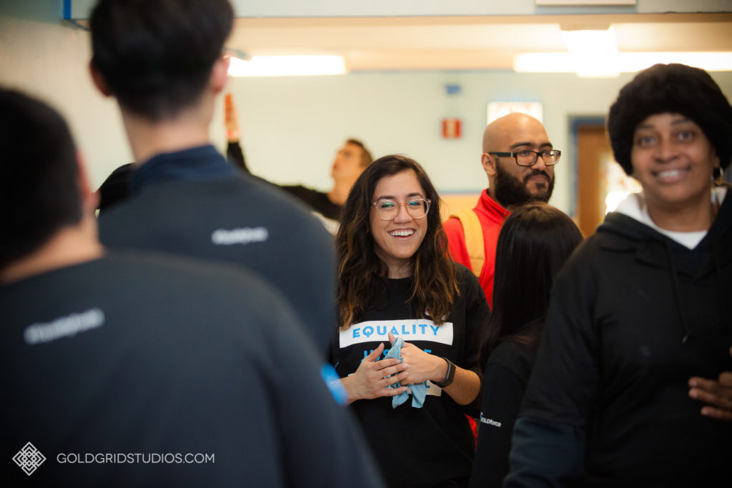 A Salesforce team member laughs amongst her colleagues as they encourage each other's service work on MLK Day in Chicago.
