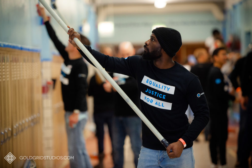 A Salesforce team member helps beautify the hallways of Deneen Elementary School on MLK Day in Chicago.