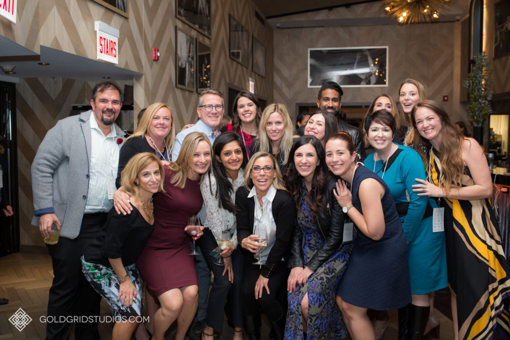 Rebecca Ickes, founder of Gold Grid Studios (front row, right), joins a group photo with other industry professionals.