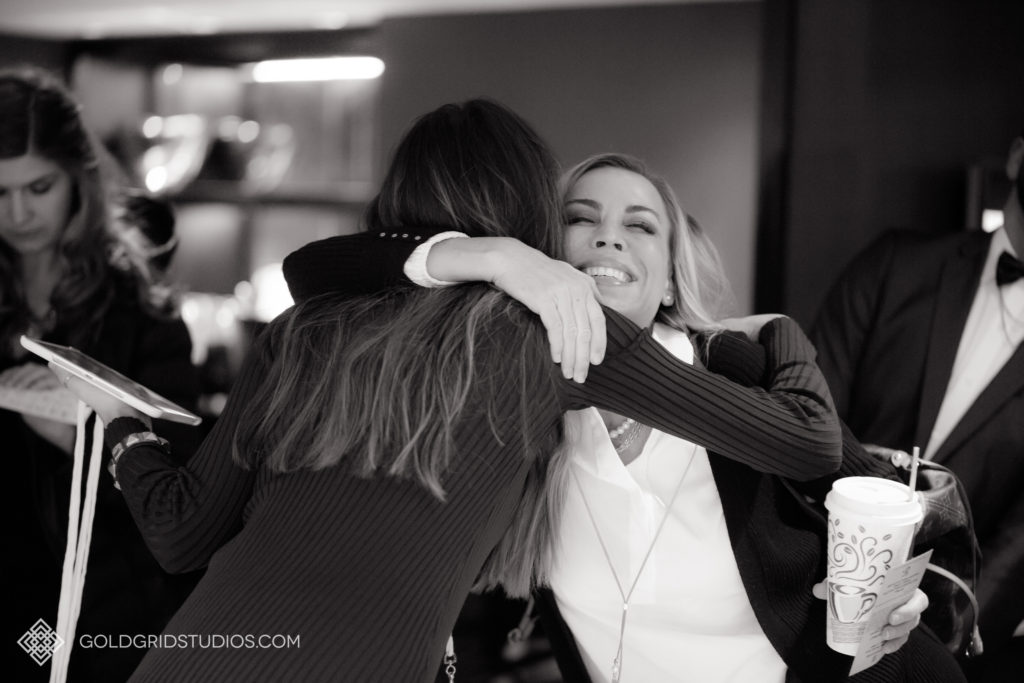 Two women hug to say hello at The Knot Workshop in Chicago.