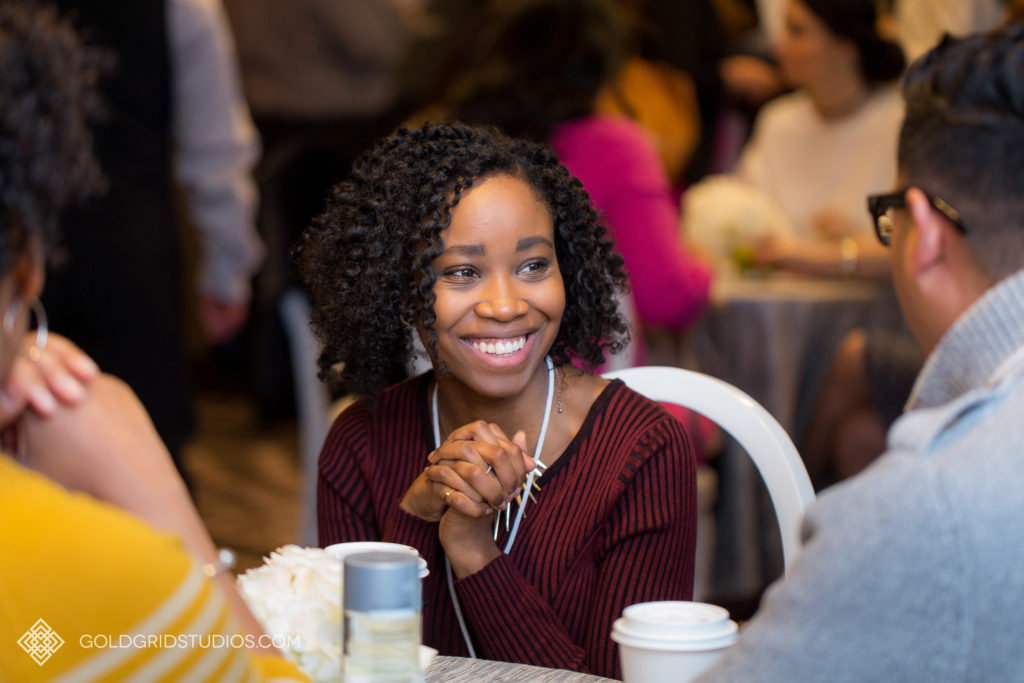 A woman networks with another conference attendee at The Knot Workshop in Chicago.
