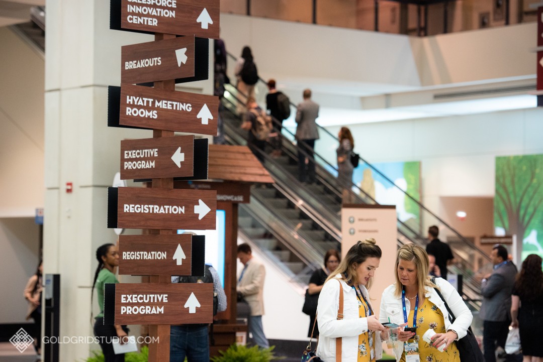Attendees at Salesforce Connections 2019 at McCormick Place look at their conference guide.