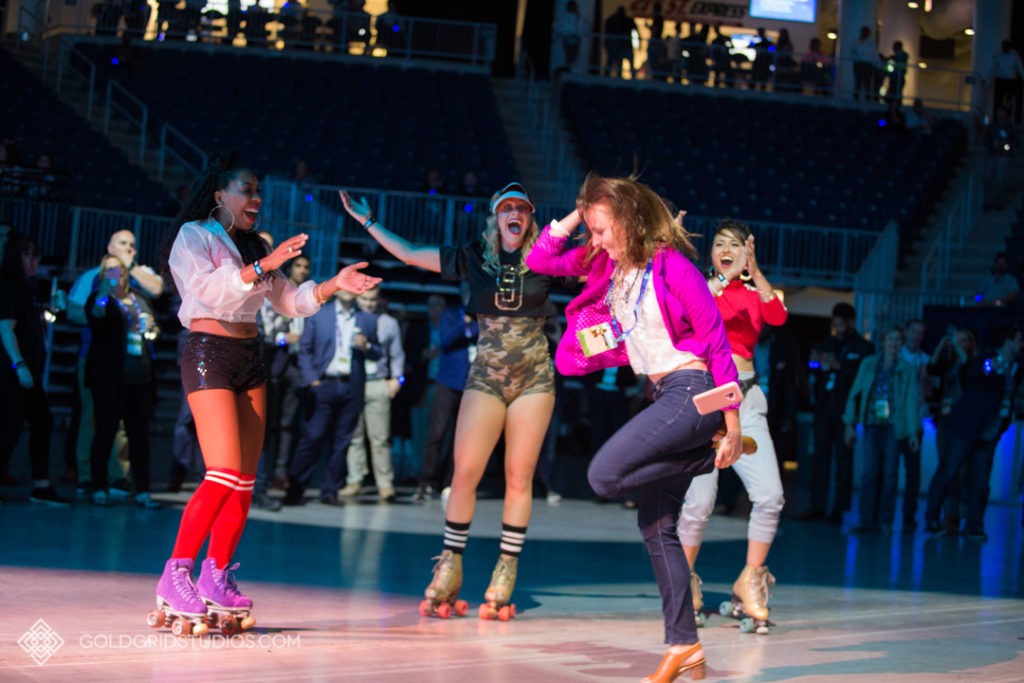 Conference attendee dances with roller girls